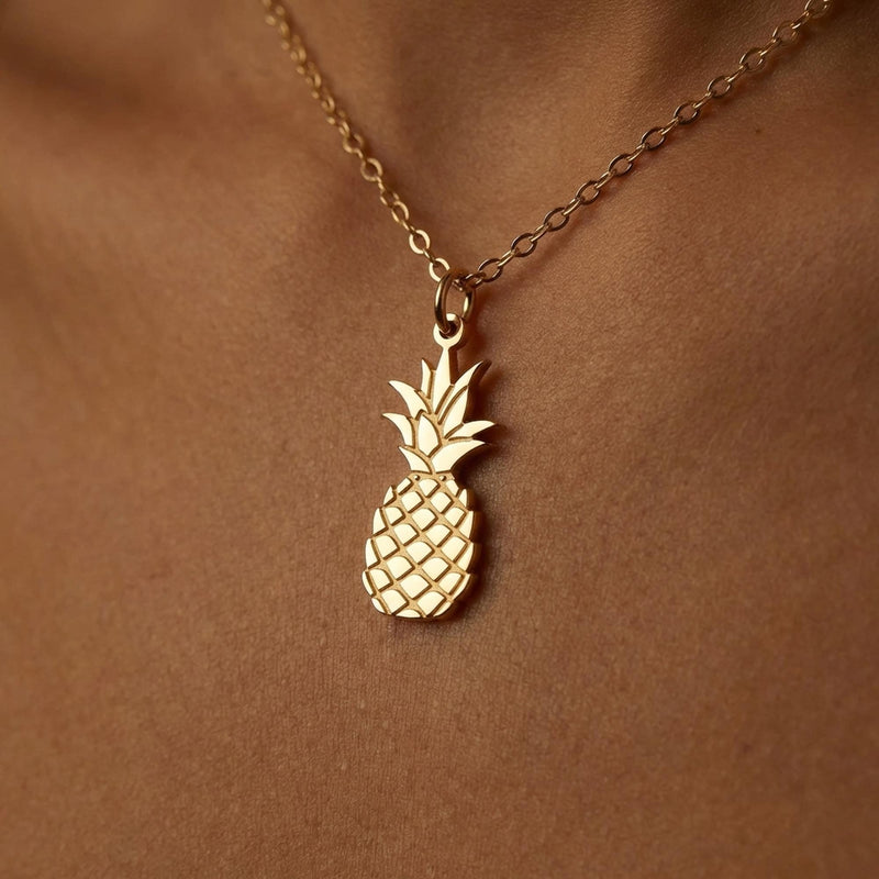 Small pineapple pendant with leaf crown on a thin gold chain