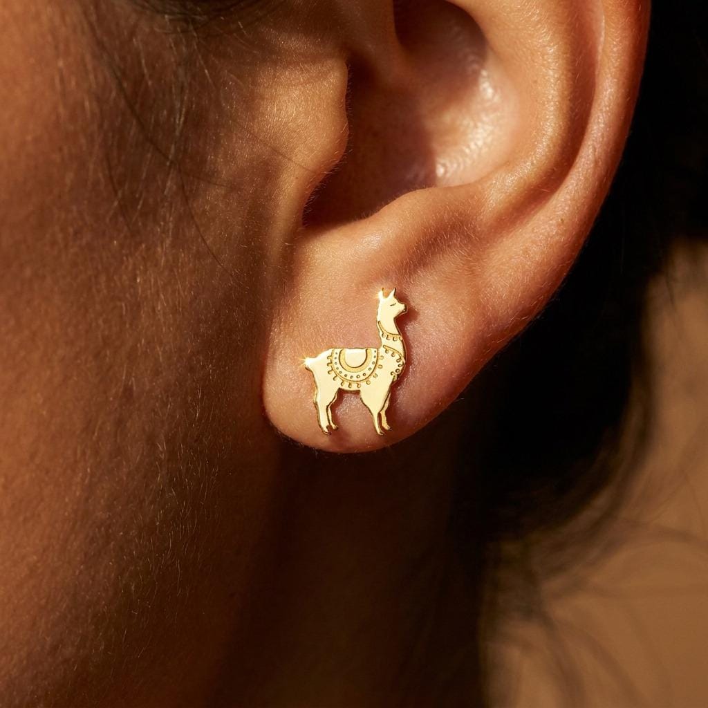 Pair of tiny gold llama stud earrings with tufted heads, shown on white (2 of 12)