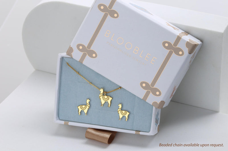 Pair of tiny gold llama stud earrings with tufted heads, shown on white (8 of 12)