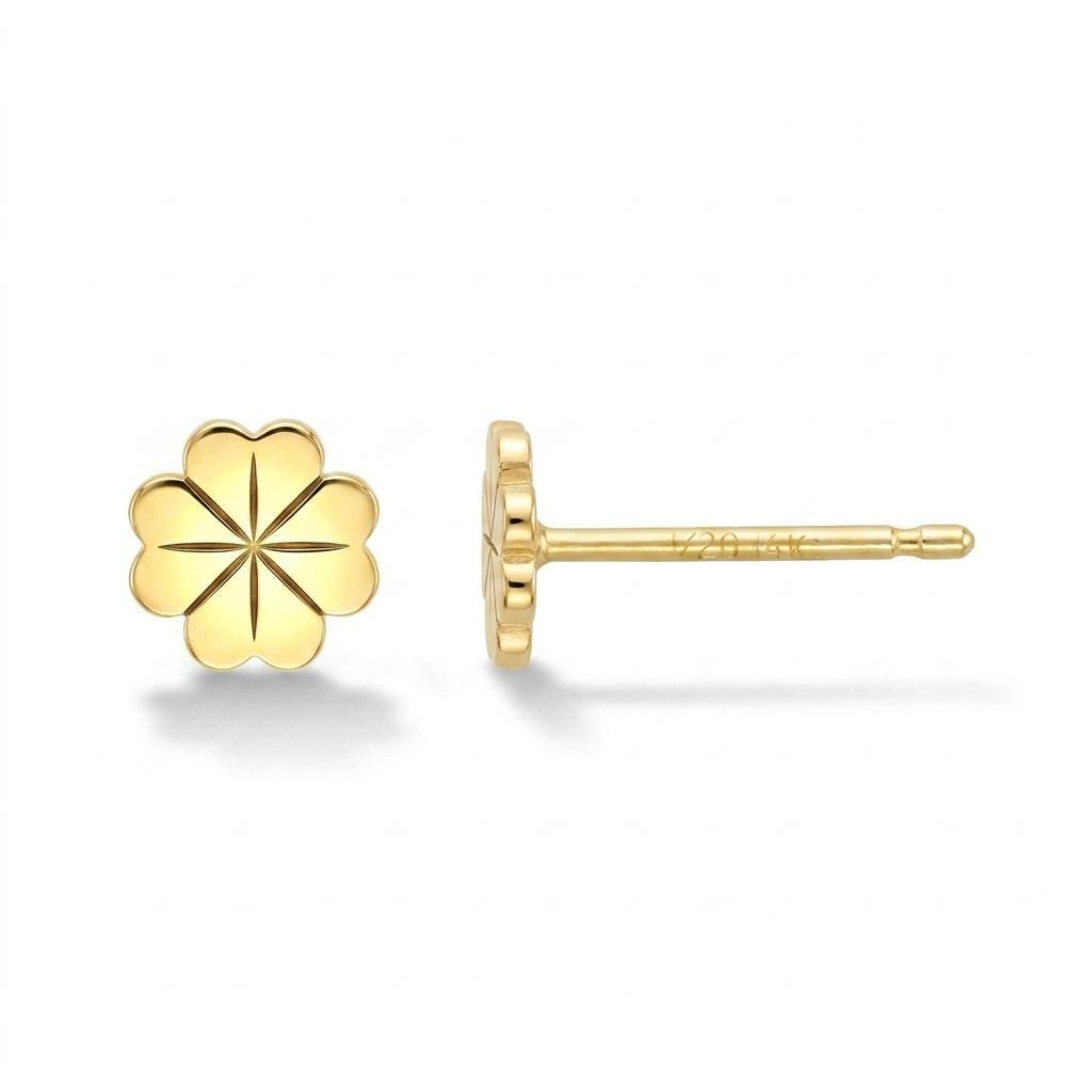 Tiny gold four leaf clover stud earrings shown as a pair on a plain background