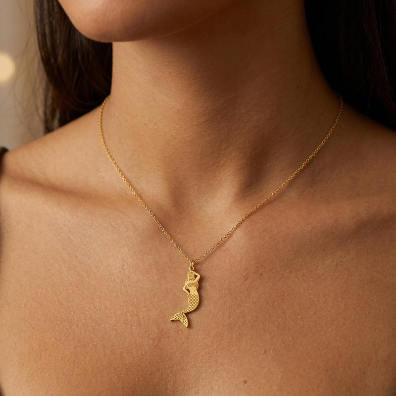Small gold mermaid pendant with curled tail and sweeping hair on a thin chain (2 of 11)