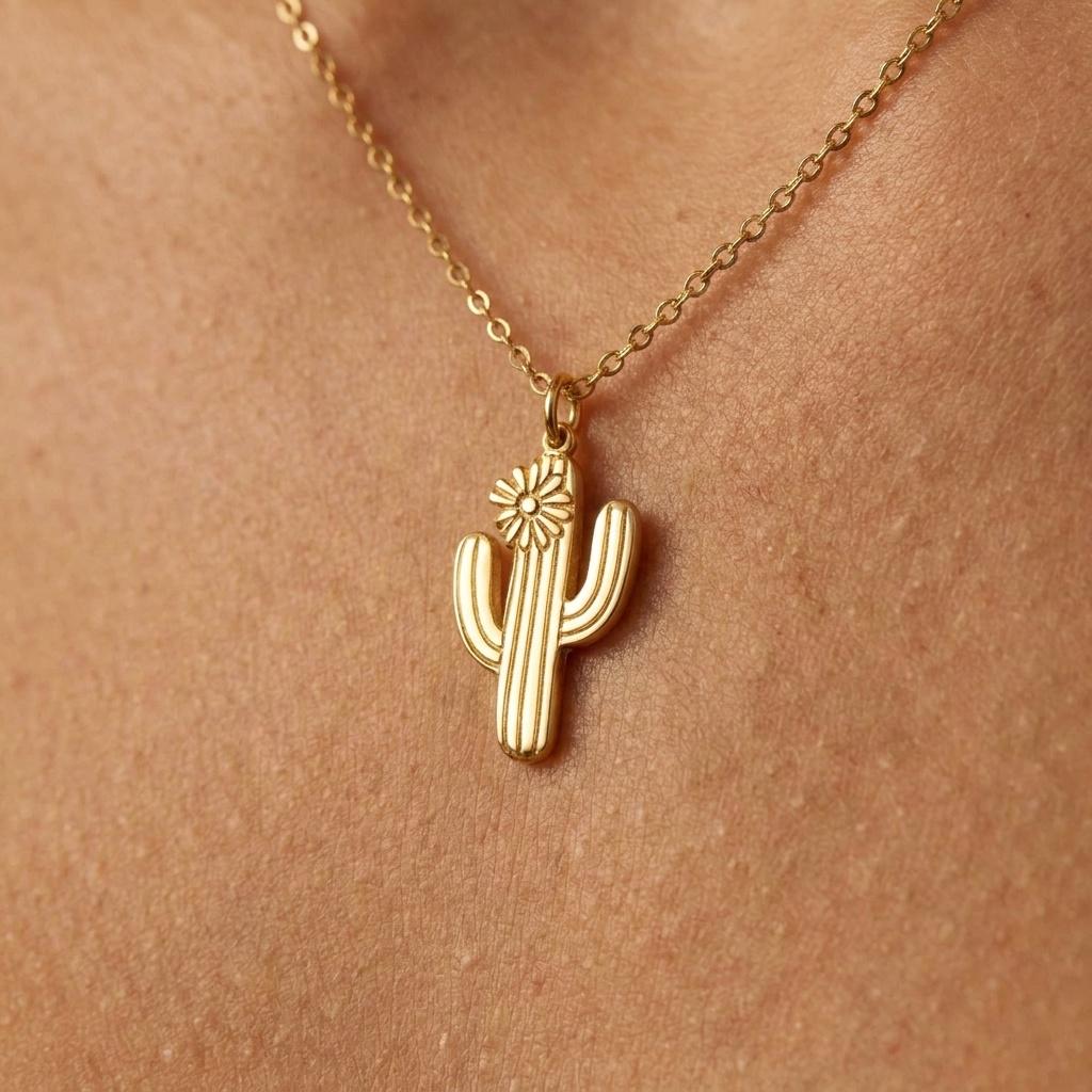 Small gold saguaro cactus pendant on a thin chain, shown on a white background.