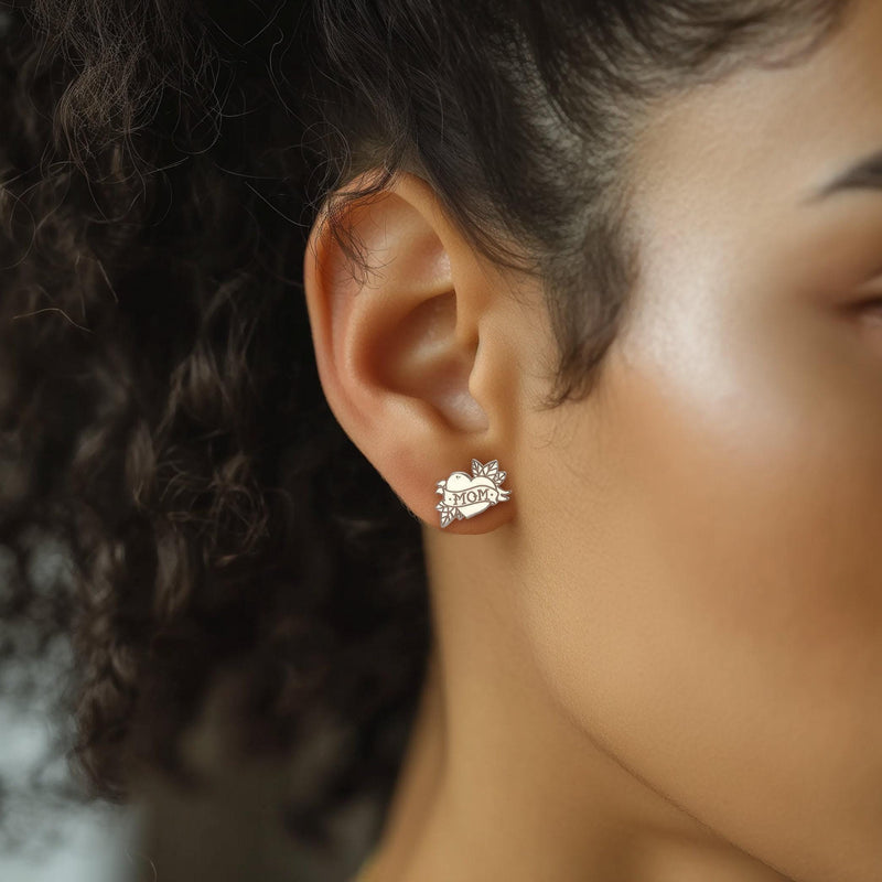 Pair of gold stud earrings shaped like a tattoo heart with a MOM banner (6 of 9)