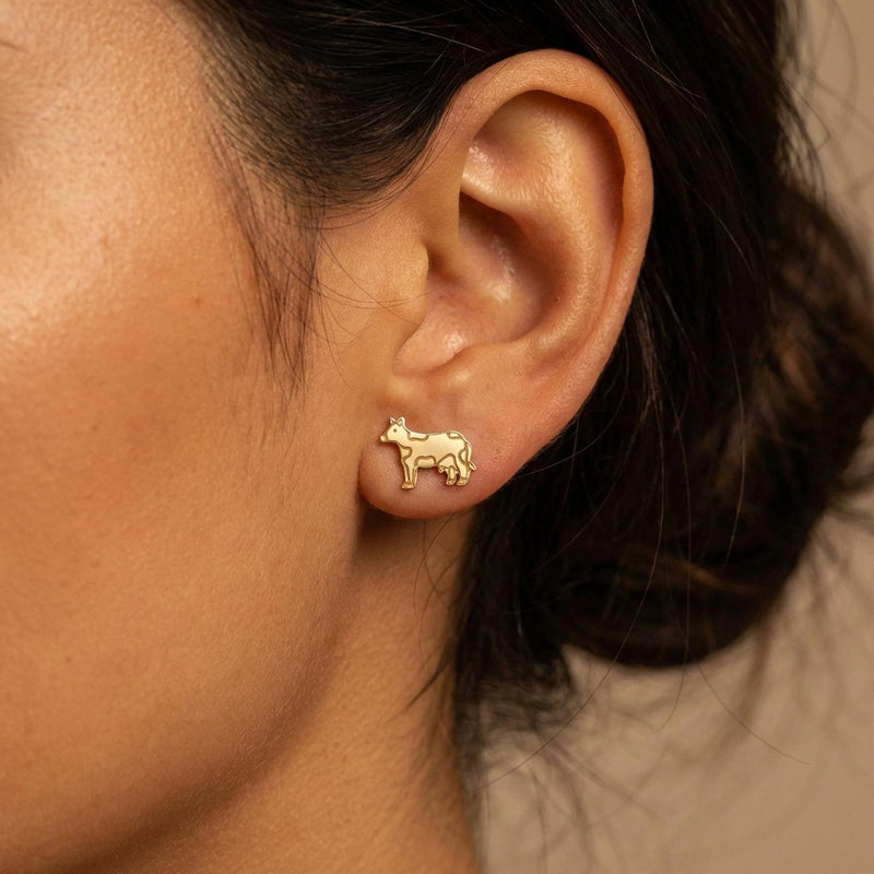 Pair of small highland cow face stud earrings in gold, fringe and ears visible (4 of 9)