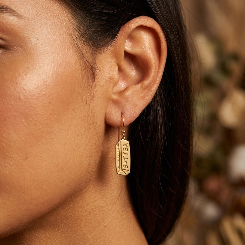 Pair of gold butter stick drop earrings hanging from small posts (7 of 10)