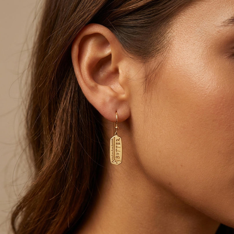 Pair of gold butter stick drop earrings hanging from small posts (8 of 10)