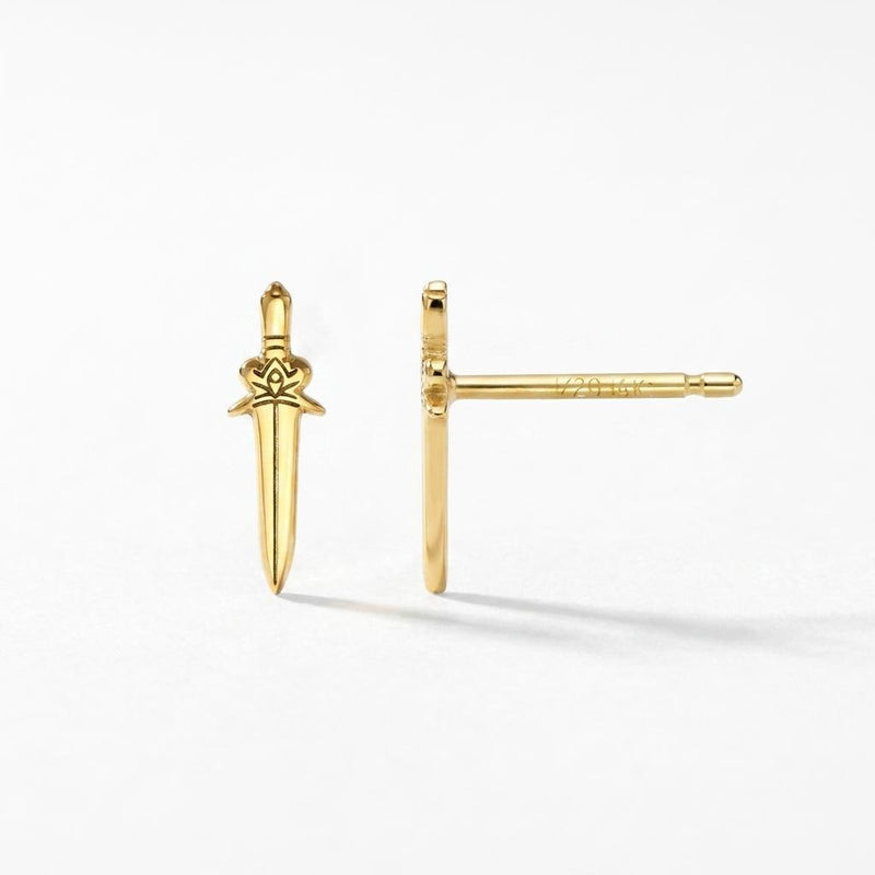 Pair of slim dagger stud earrings in gold pointing downward