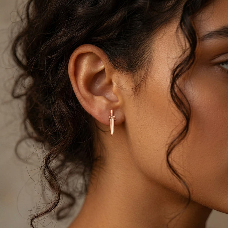 Pair of slim dagger stud earrings in gold pointing downward (3 of 6)