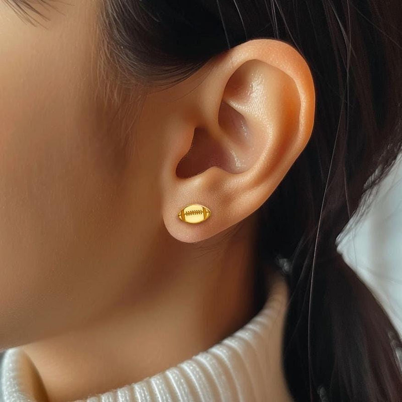 Pair of small gold football stud earrings with cut in laces (5 of 9)