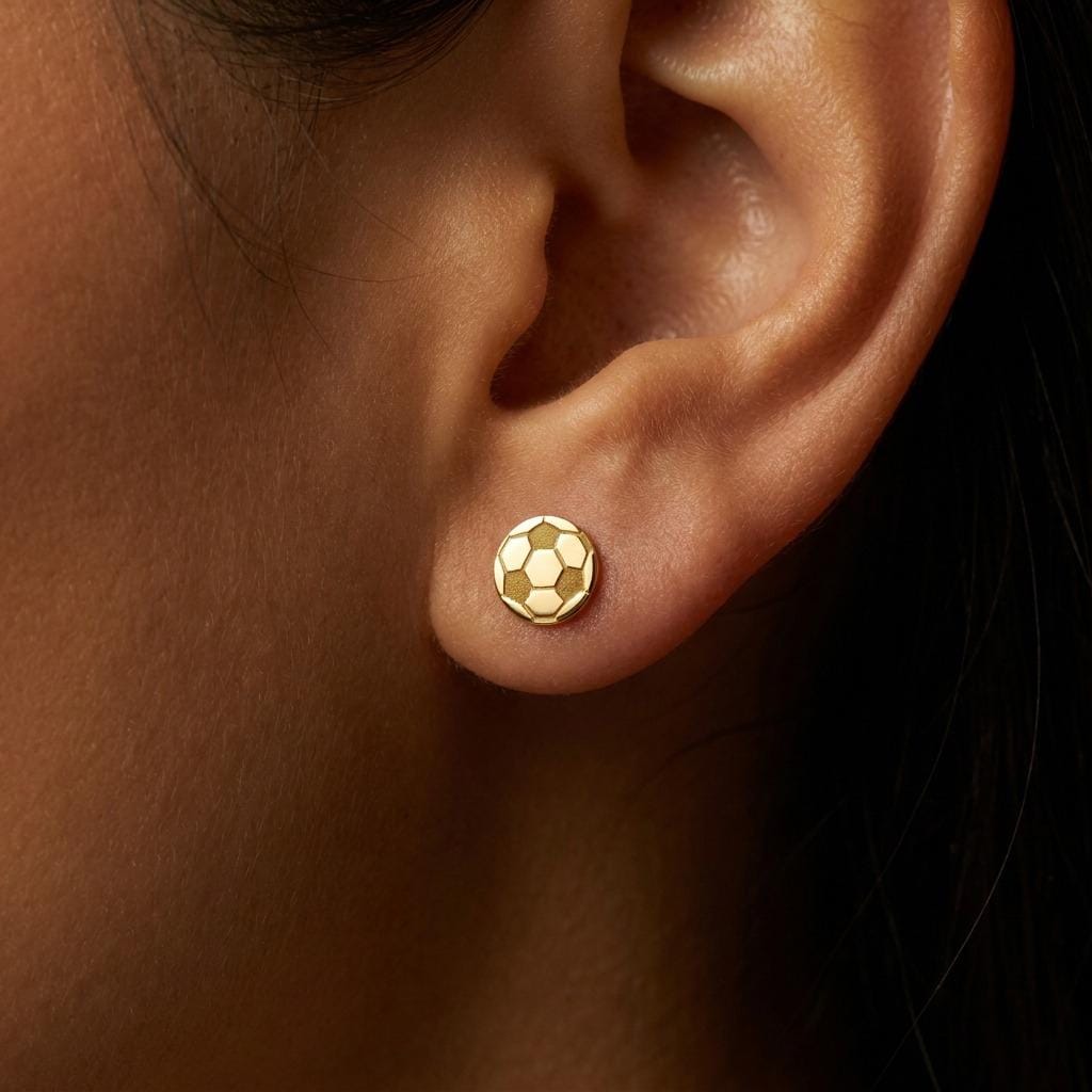 Pair of tiny round gold soccer ball stud earrings with cut in panels