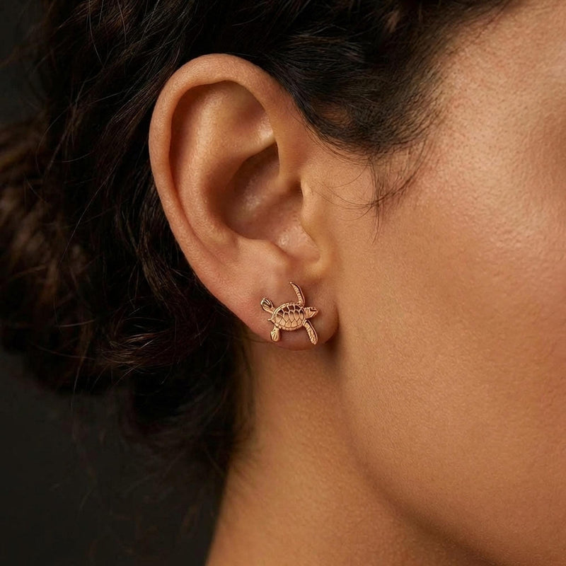 Pair of small turtle stud earrings in gold seen from above with a patterned shell (6 of 9)