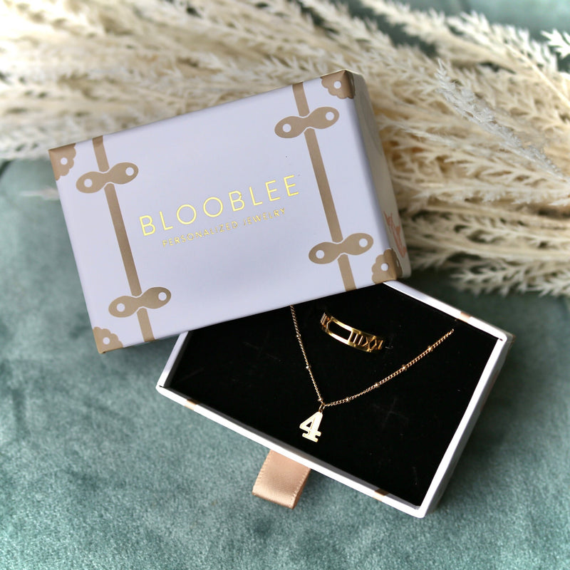 Thin gold stacking ring with a tiny baseball on the top of the band (5 of 9)