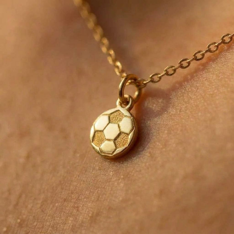 Small gold soccer ball charm necklace with pentagon panels on a fine chain
