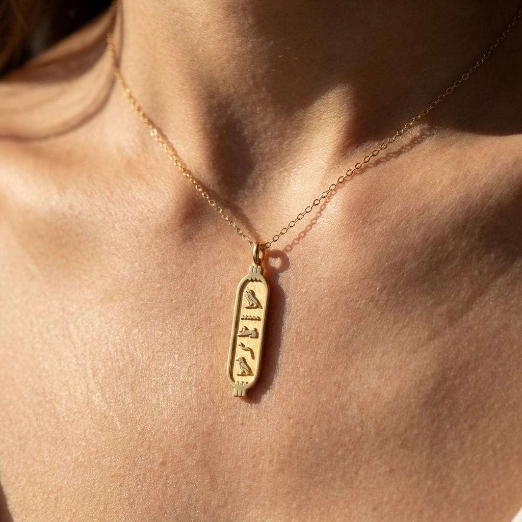 Elongated gold cartouche pendant on a fine cable chain, shown on white (2 of 11)