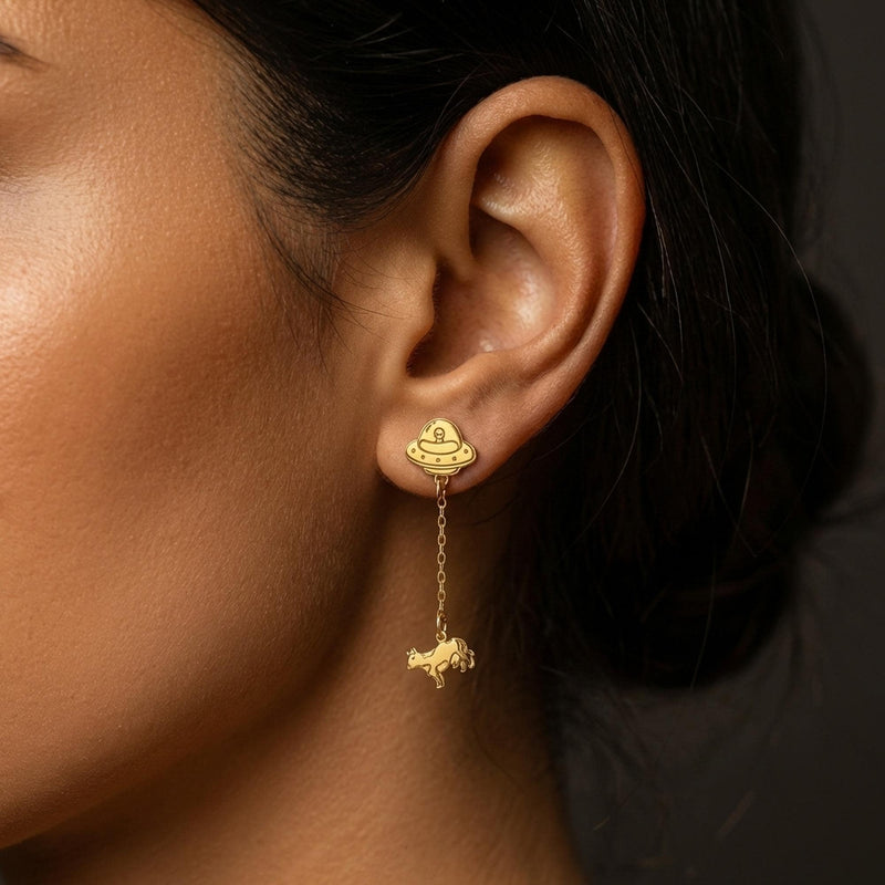 Tiny gold stud earrings showing a UFO beaming up a small cow (2 of 13)