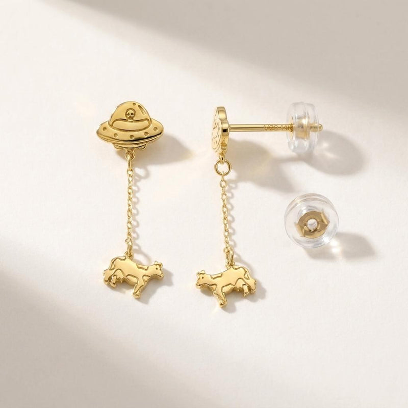 Tiny gold stud earrings showing a UFO beaming up a small cow (4 of 13)