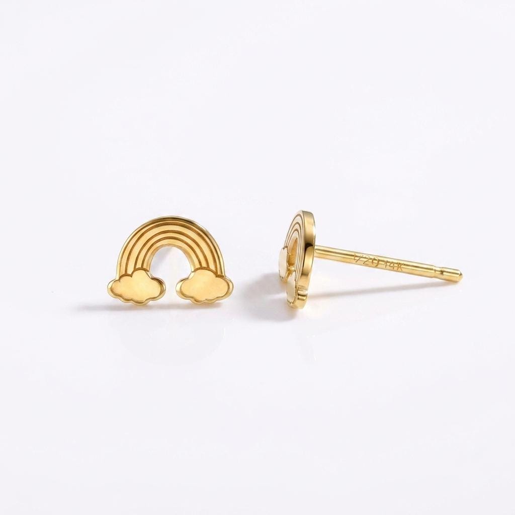 Tiny gold rainbow arc stud earrings in polished metal on posts