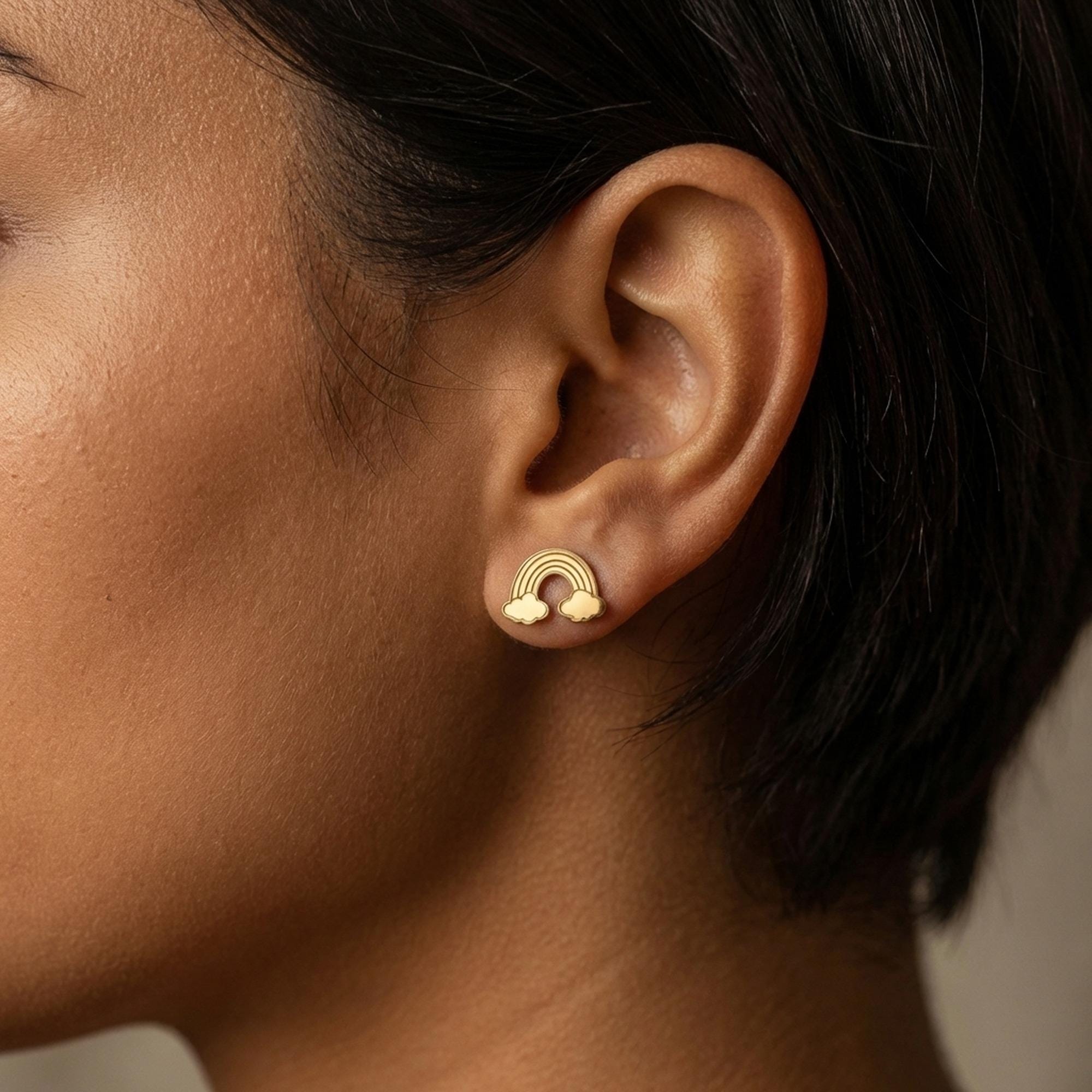 Tiny gold rainbow arc stud earrings in polished metal on posts (2 of 9)