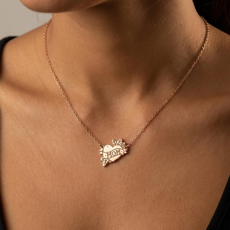 Tattoo style heart pendant with a banner on a thin gold chain