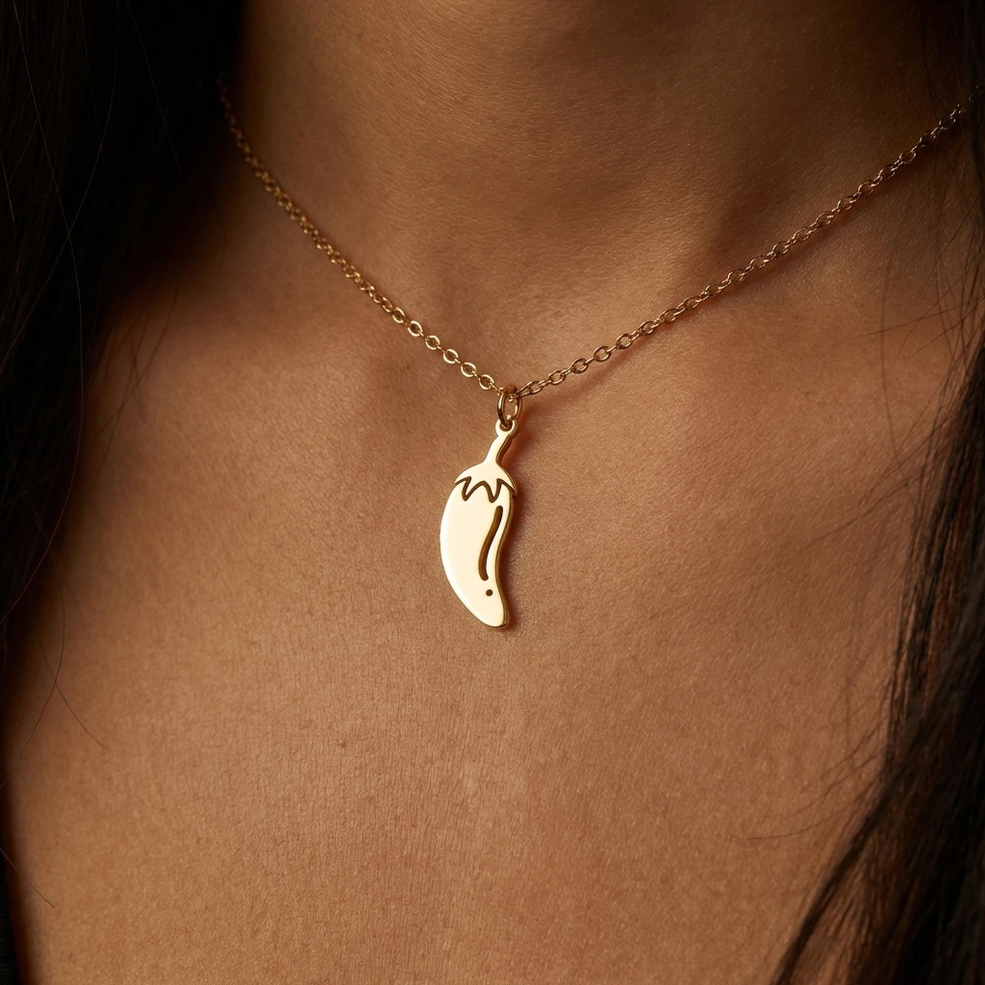 Fine gold necklace with a small curved chili pepper pendant (2 of 12)