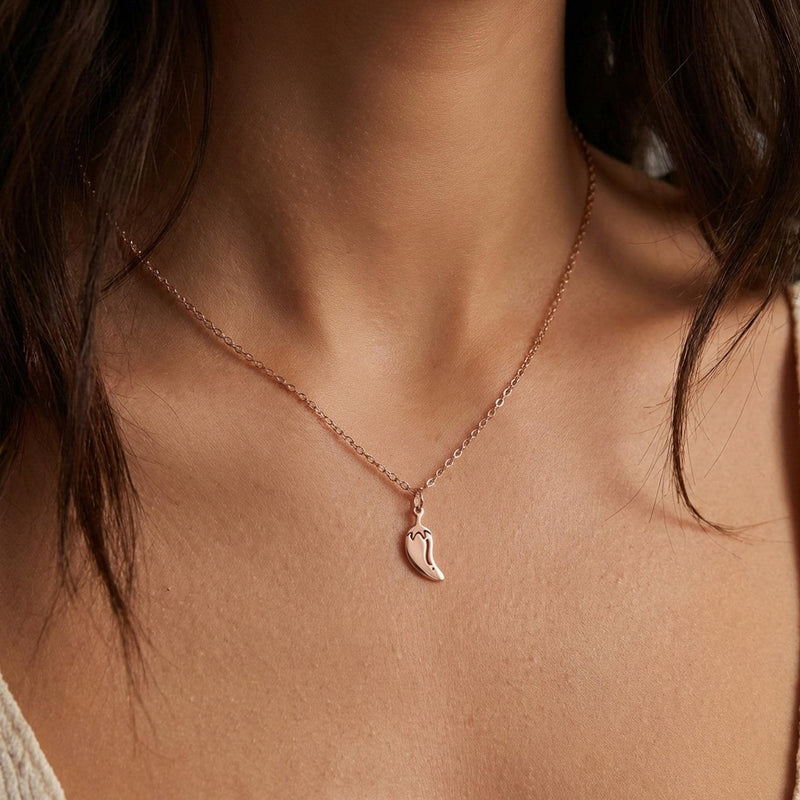 Fine gold necklace with a small curved chili pepper pendant (5 of 12)