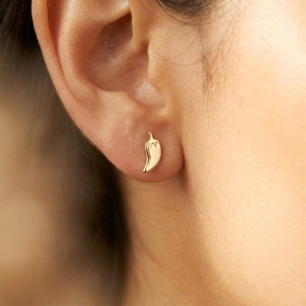 Pair of slim chili pepper stud earrings in gold with a small stem at the top (2 of 12)