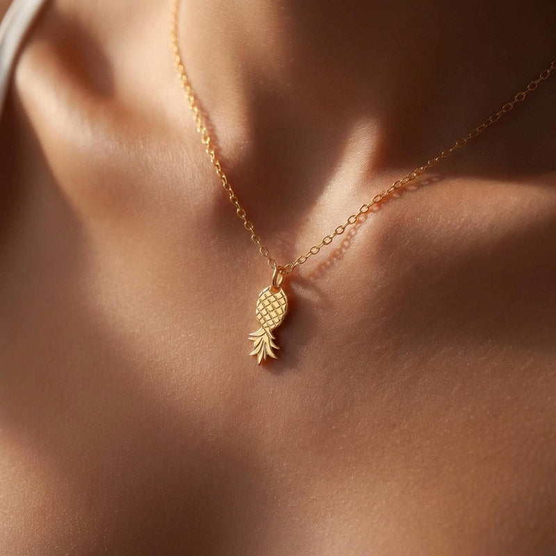Fine gold chain necklace with a small pineapple pendant hanging point down (2 of 9)