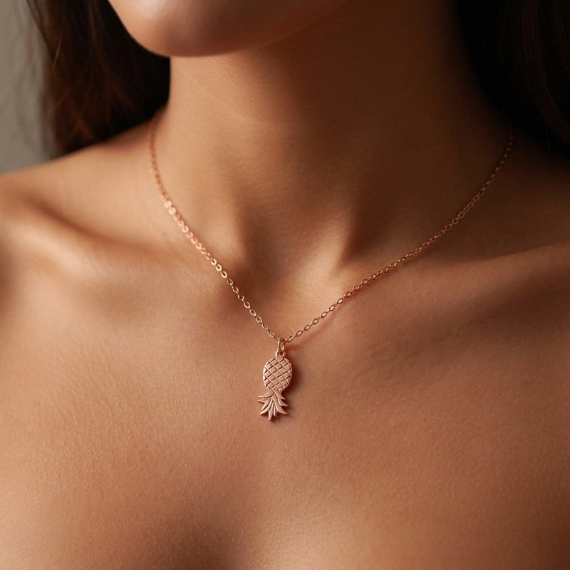 Fine gold chain necklace with a small pineapple pendant hanging point down (7 of 9)