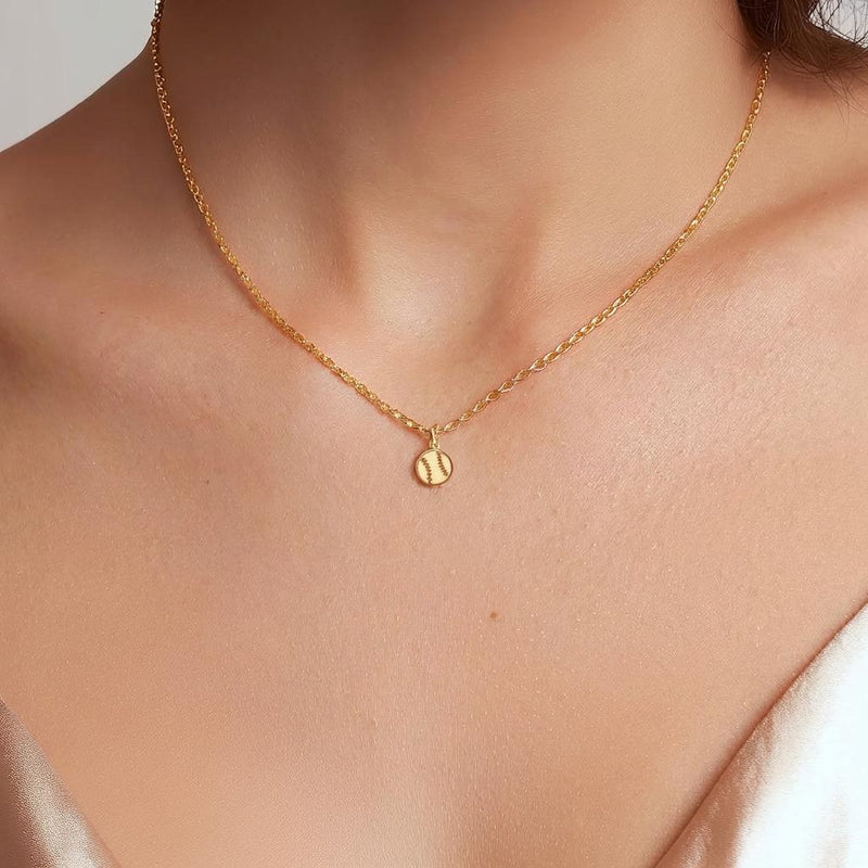 Fine gold chain necklace with a tiny round baseball pendant with stitching (11 of 13)