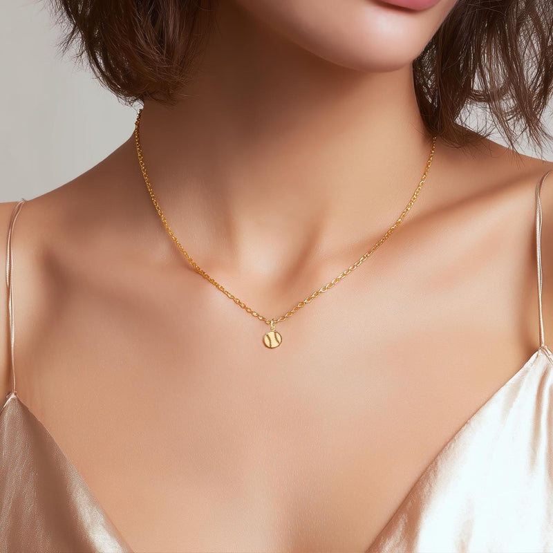 Fine gold chain necklace with a tiny round baseball pendant with stitching (13 of 13)