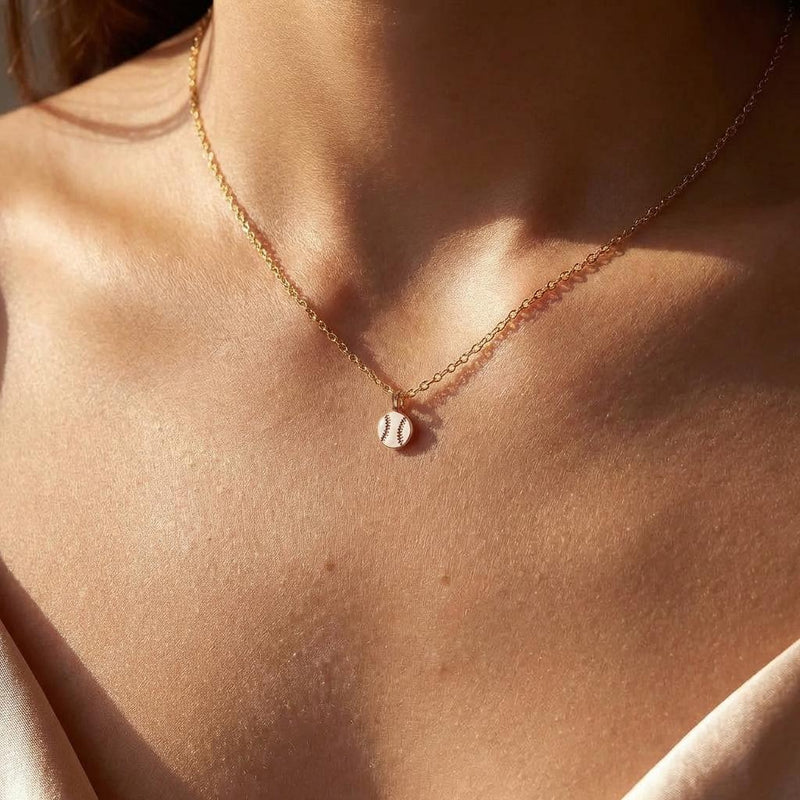 Fine gold chain necklace with a tiny round baseball pendant with stitching (3 of 13)