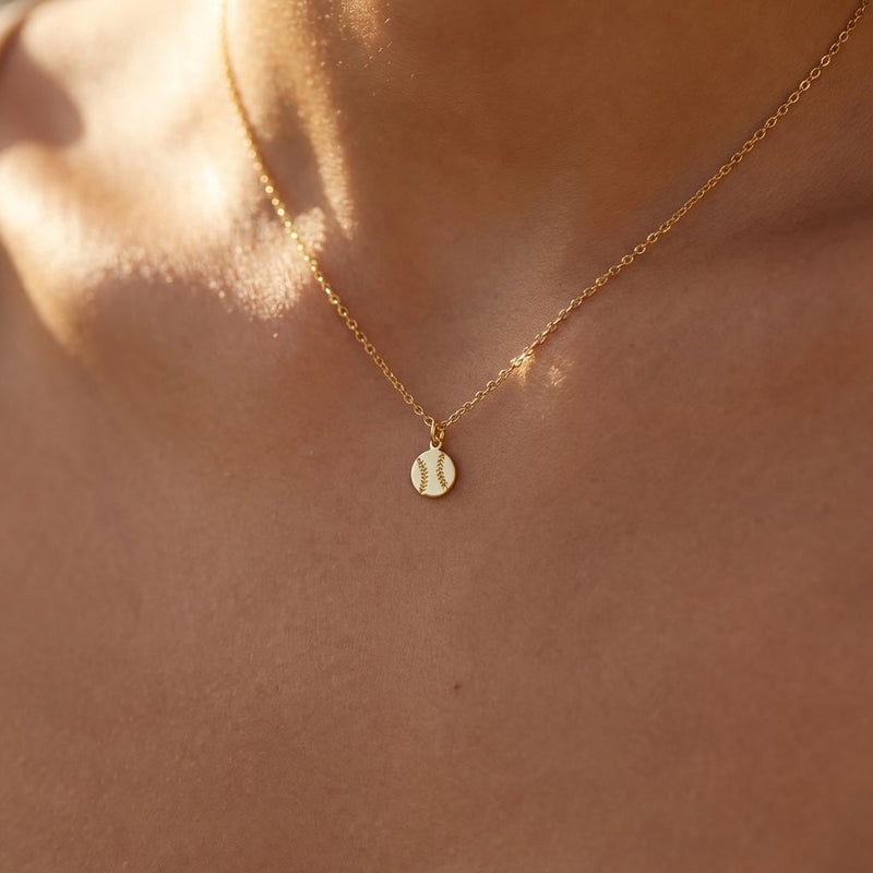Fine gold chain necklace with a tiny round baseball pendant with stitching (4 of 13)