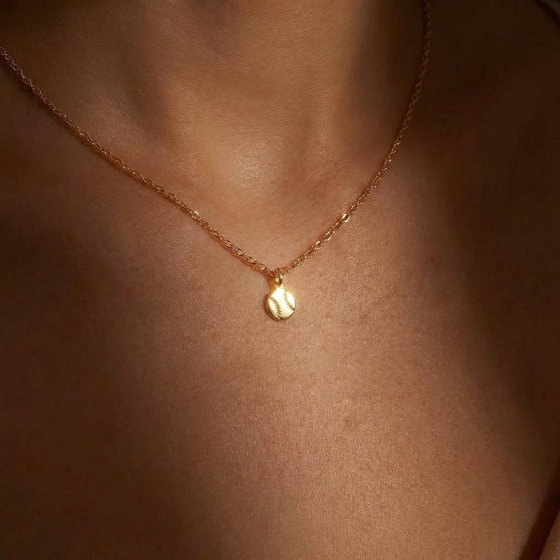Fine gold chain necklace with a tiny round baseball pendant with stitching (5 of 13)