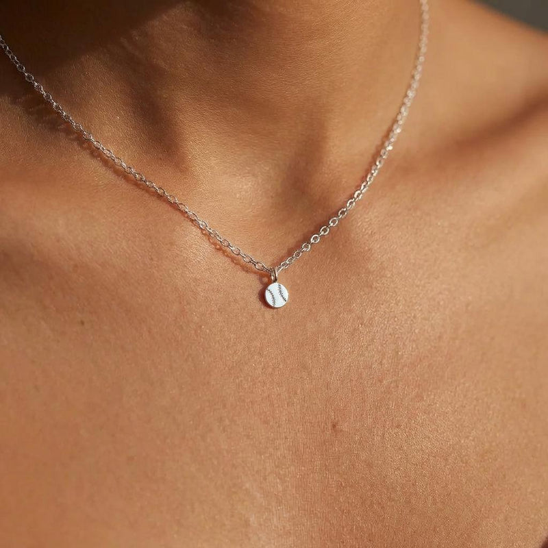 Fine gold chain necklace with a tiny round baseball pendant with stitching (6 of 13)