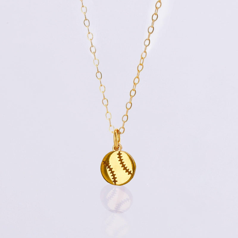 Fine gold chain necklace with a tiny round baseball pendant with stitching (7 of 13)