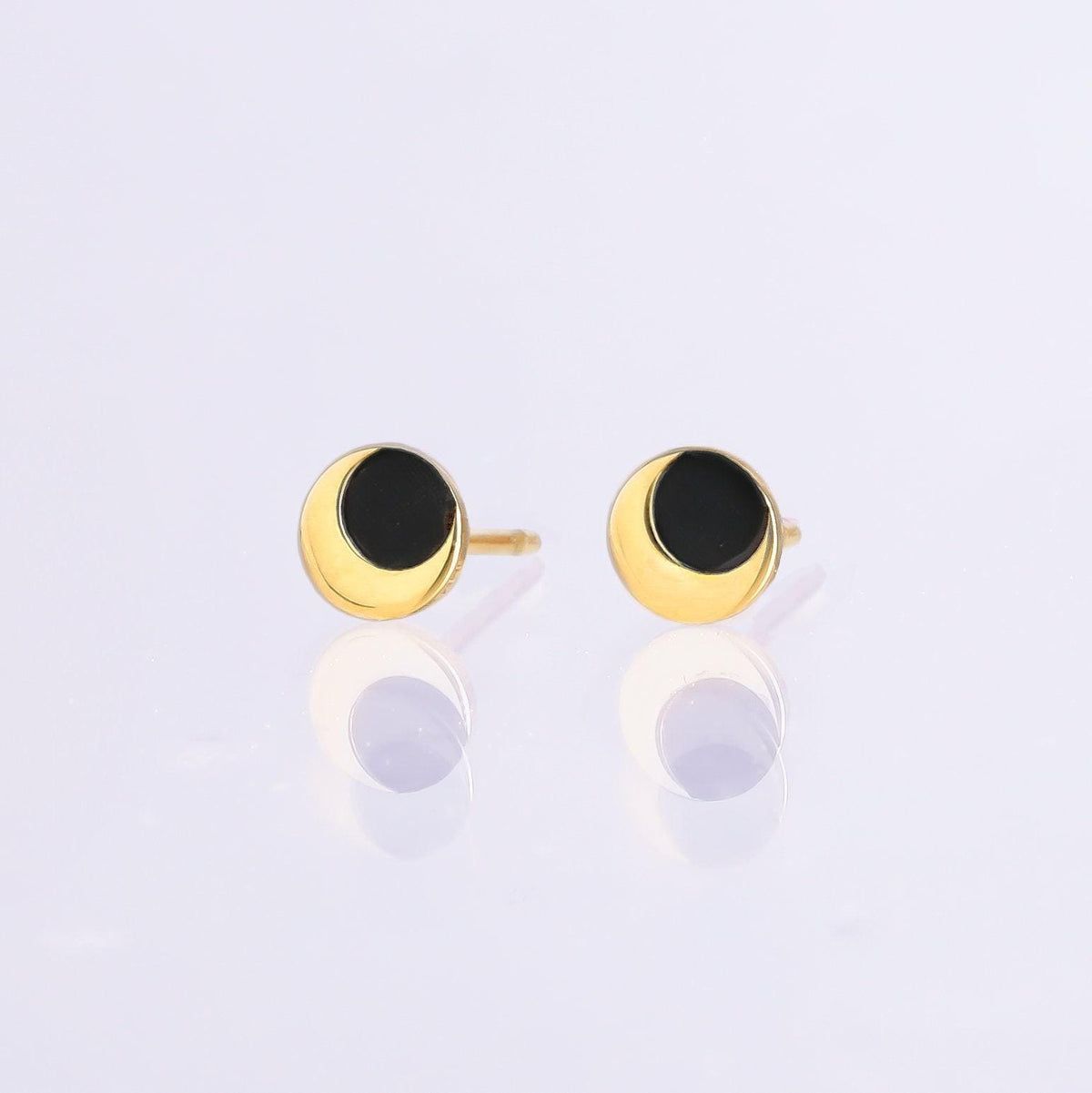 Pair of tiny gold eclipse stud earrings with one disc overlapping another