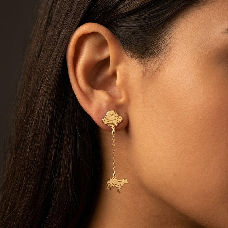 Pair of gold drop earrings showing a flying saucer beaming up a tiny cow (11 of 12)