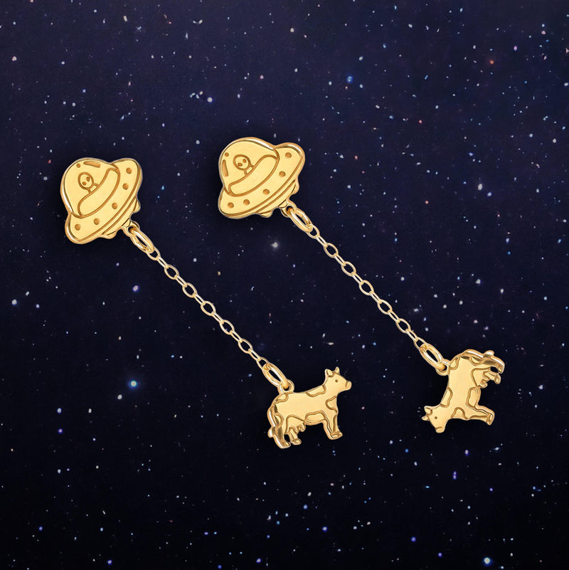 Pair of gold drop earrings showing a flying saucer beaming up a tiny cow (2 of 12)