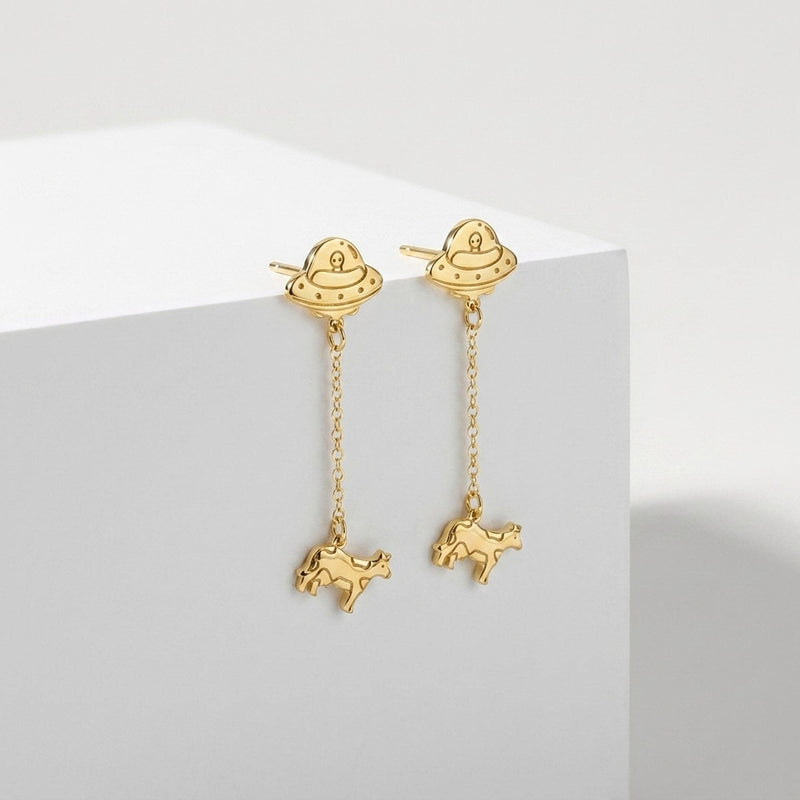 Pair of gold drop earrings showing a flying saucer beaming up a tiny cow (3 of 12)