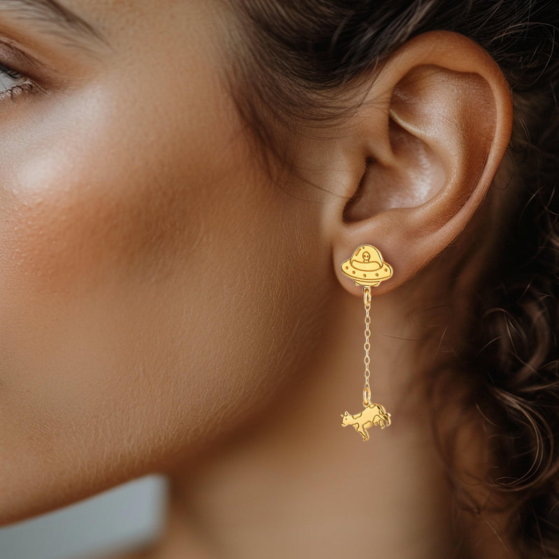 Pair of gold drop earrings showing a flying saucer beaming up a tiny cow (4 of 12)