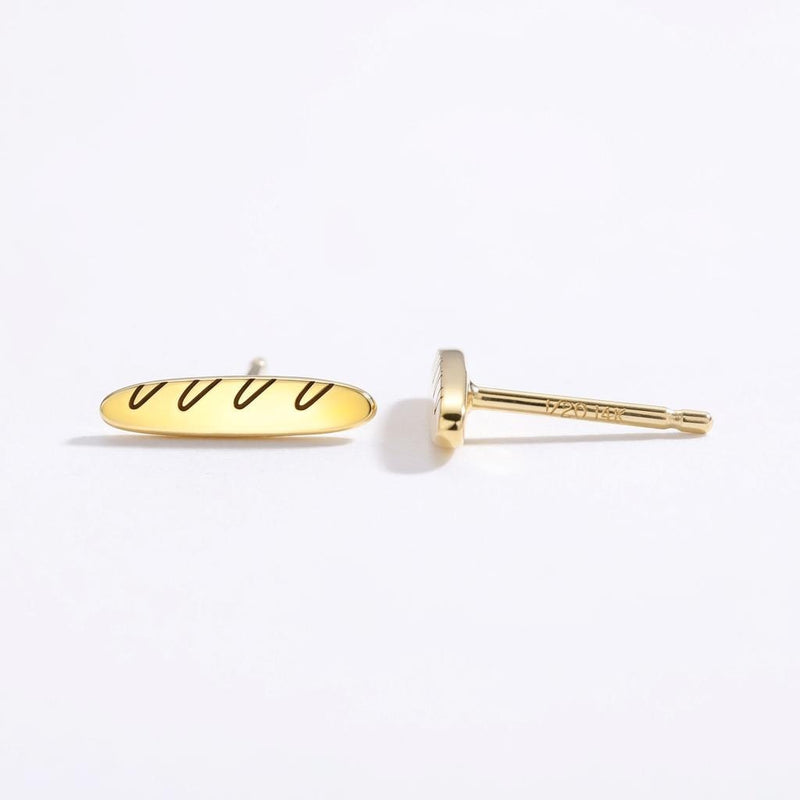 Pair of slim gold baguette bread stud earrings with scored tops