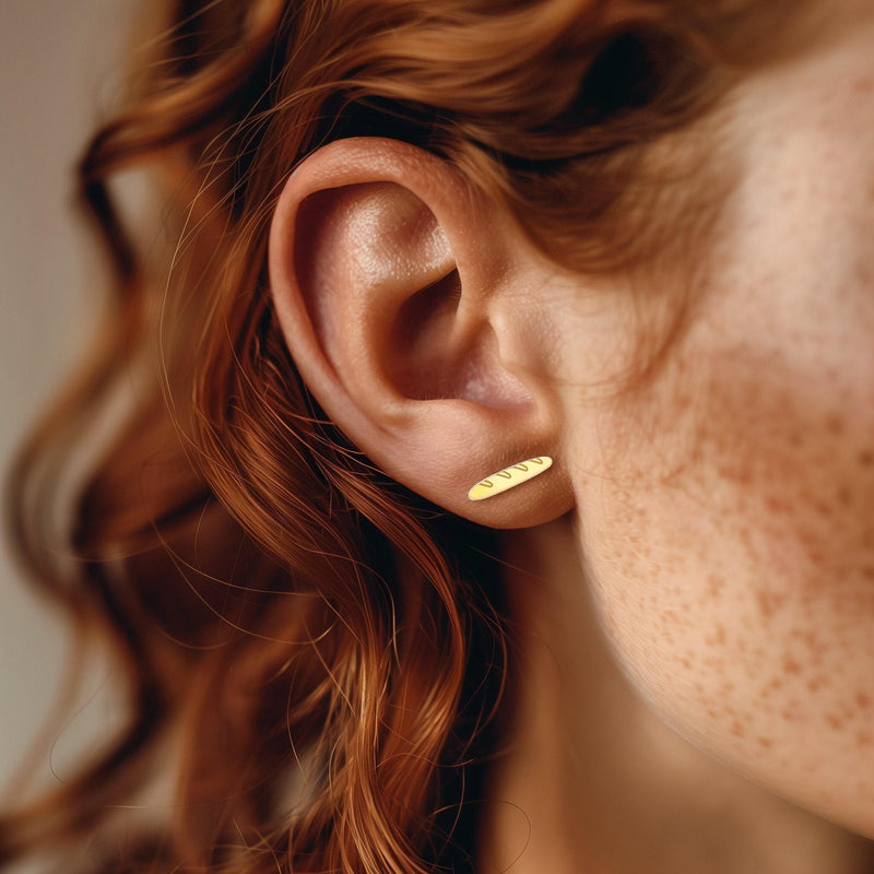 Pair of slim gold baguette bread stud earrings with scored tops (11 of 11)