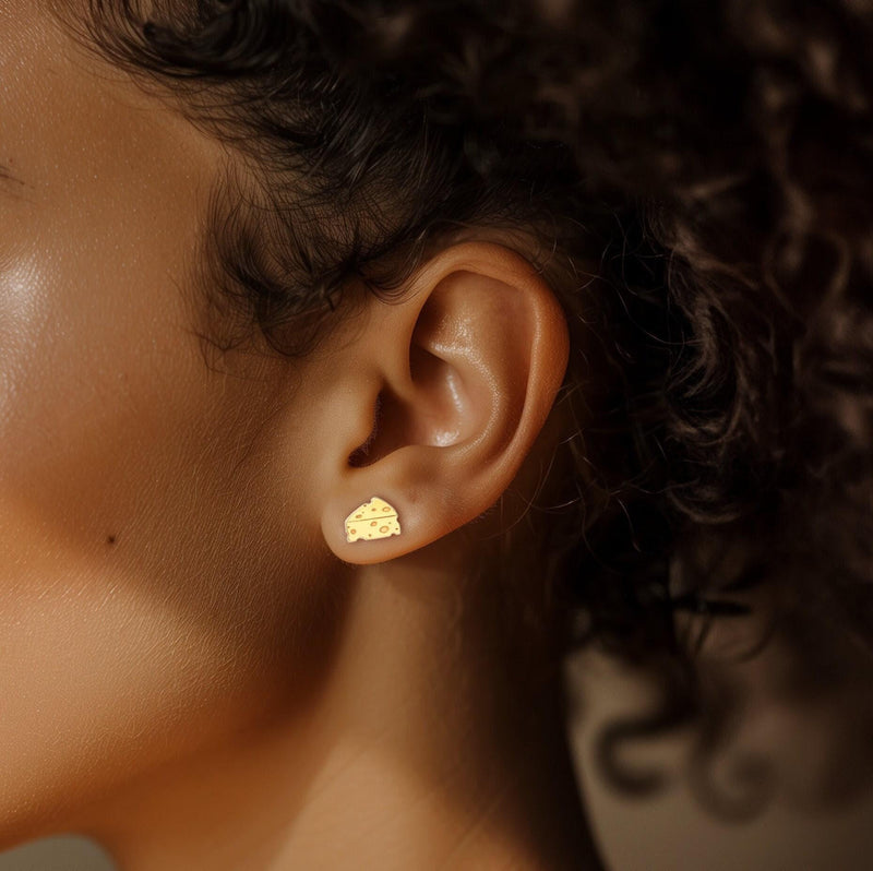 Small gold cheese wedge stud earrings with cutout holes, shown as a pair (7 of 12)