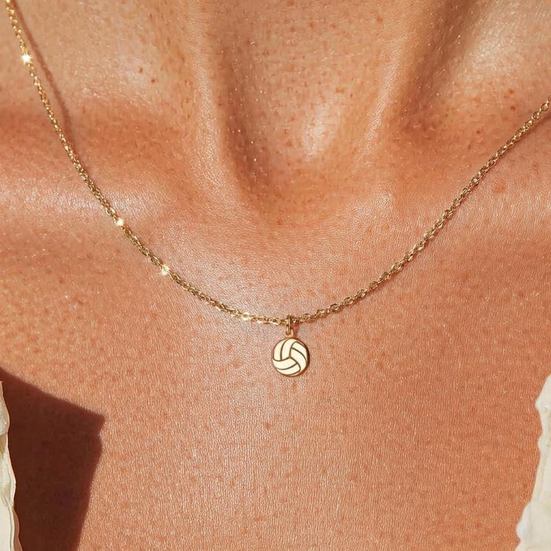 Very small gold volleyball pendant on a fine cable chain