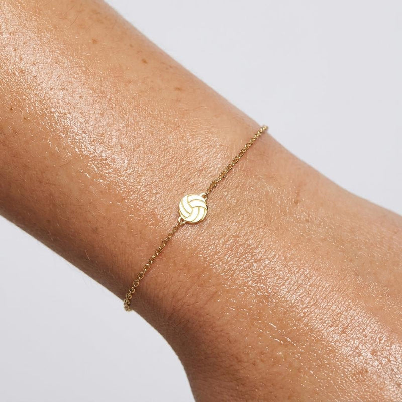 Thin gold chain bracelet with a small volleyball charm with curved panels (2 of 11)