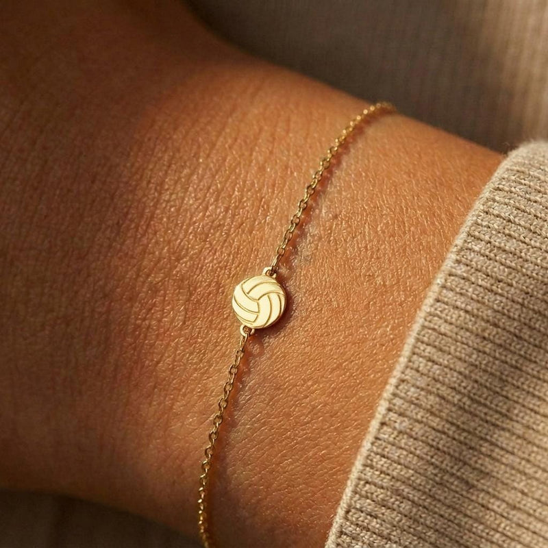 Thin gold chain bracelet with a small volleyball charm with curved panels (3 of 11)