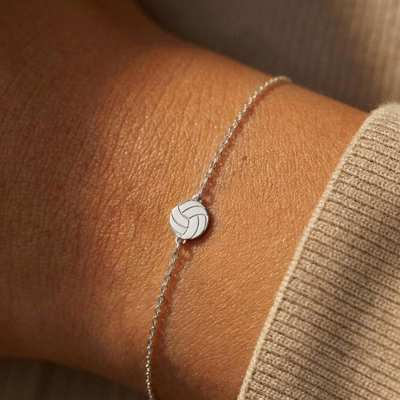 Thin gold chain bracelet with a small volleyball charm with curved panels (4 of 11)
