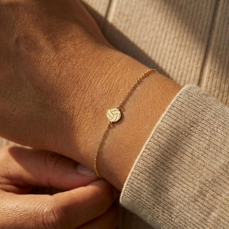 Thin gold chain bracelet with a small volleyball charm with curved panels (5 of 11)