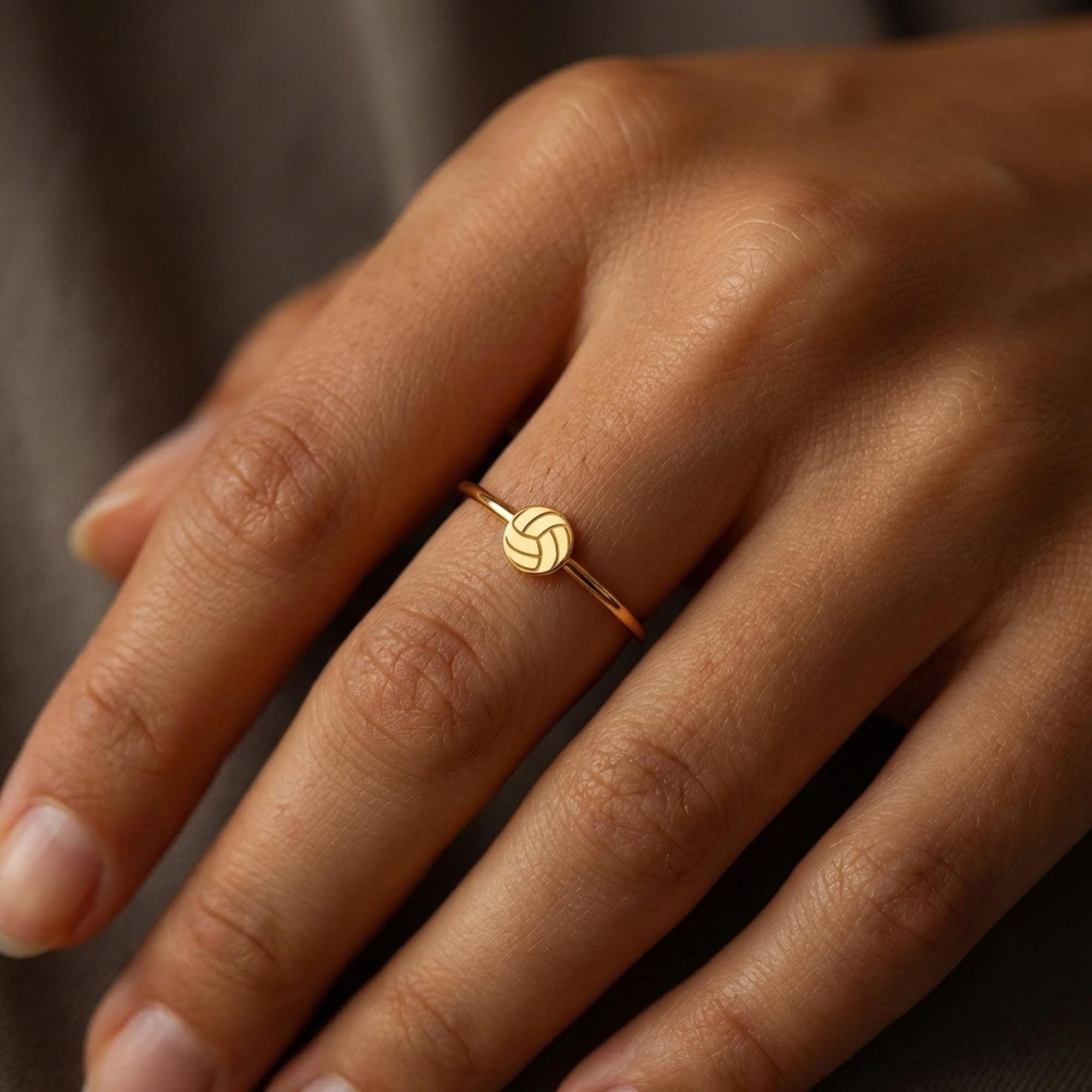Thin gold stacking ring with a tiny volleyball charm sitting flat on the band (2 of 7)
