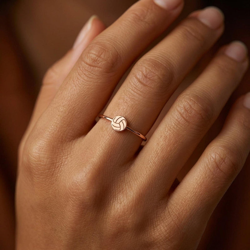 Thin gold stacking ring with a tiny volleyball charm sitting flat on the band (4 of 7)